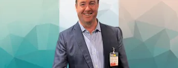 John Dawson stood in front of a Irish Flag